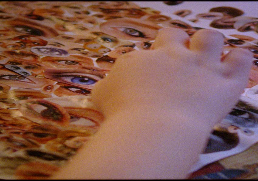 A hand moving eye photo cutouts
